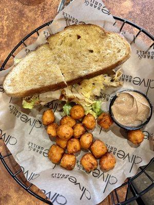 Sandwich with sweet potato tots.