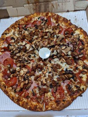 Pepperoni, Ham, Sausage, Mushrooms and Cashews Large thin crust Pizza. Very Good!