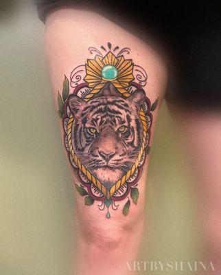 Mixed style tattoo. Color, neotraditional style border and black and grey realism tiger portrait tattoo.