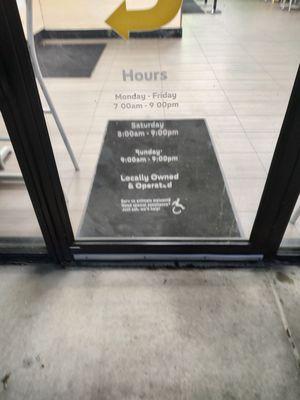 Picture of door showing the posted hours.