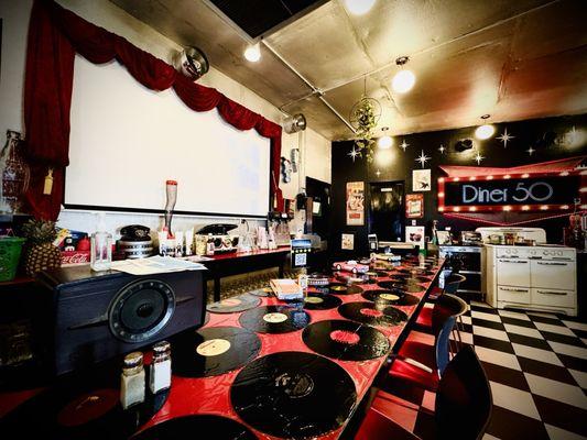 Countertop dining with a screen projector in front displaying the Andy Griffin Show