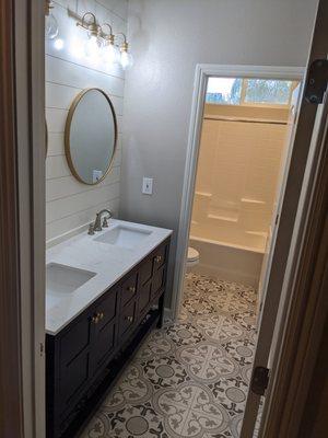 Bathroom update with new tile floor, shiplap walls, new vanity and top.