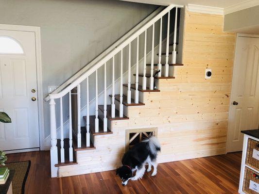 Dog house under the stairs outside decoration wood siding