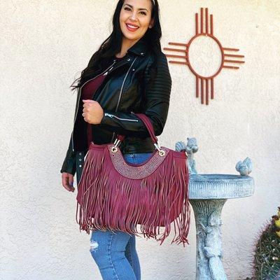 Faux leather and fringe with bling a southwest icon.