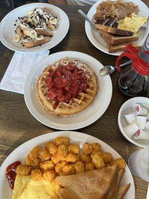 Waffle with strawberries, banana chocolate chip French toast, city line breakfast (top right), and Italian sausage omelet (bottom)