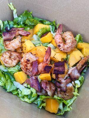 Blackened shrimp on a mango walnut and bacon salad with a lime vinaigrette