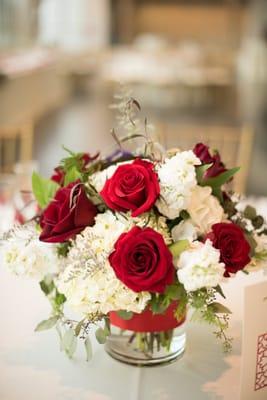 Centerpiece by Melissa: roses, hydrangea, and greenery, with an elegantly constructed texture.  Photo by Beth Baugher of True Love Photo.