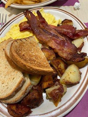 Scrambled eggs, home fries (Seasoned perfectly), rye toast, bacon (some of the best I've had), and a large pancake on the side