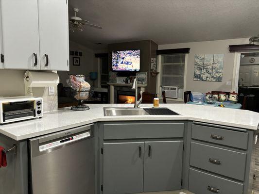 This nice light granite color replaced dark navy Formica.  MM tech made a few repairs on the old countertop & the new look is perfect.