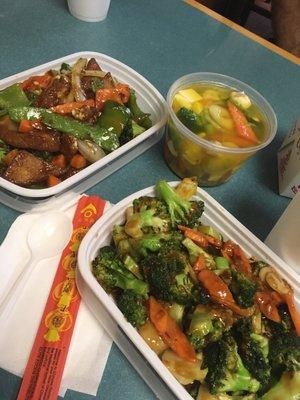 Bean curd Szechuan style, vegetable with bean curd soup, broccoli with garlic sauce. And chopsticks.