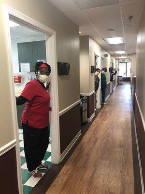 Social distanced and masked staff in hallway