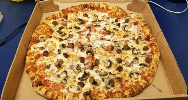 Large mushroom and sausage pizza.