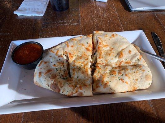 Deluxe Calzone , sausage,Pepperoni, green pepper red onions, marinara on the side.