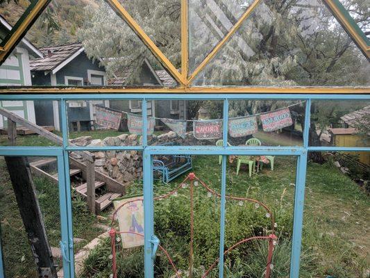 A view of the cabins from within the breakfast area/greenhouse