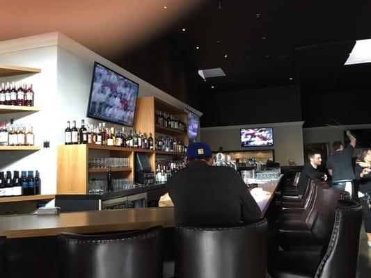 Interior shot...featuring the big screen tvs surrounding the long bar.