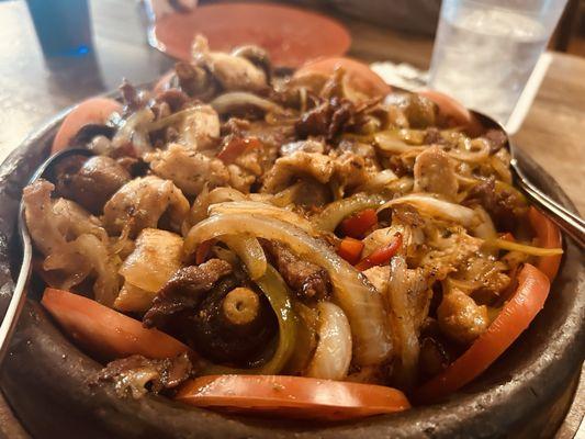 Mixed meat clay pot meal with onions mushrooms bacon etc