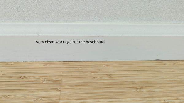 Work details along the baseboards. Very minimal scuffing of baseboards to paint over, and no line of old floor finish color. Perfect!