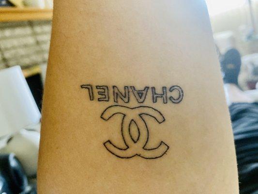 Left forearm coco Chanel tattoo.