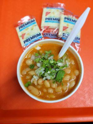 Beans Soup  with our special ingredients  topped with onions cilantro ..,...  crackers