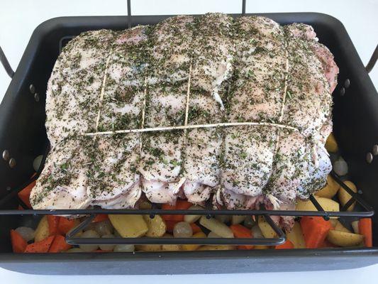 Rack of veal tied and ready for roasting with some herbs applied