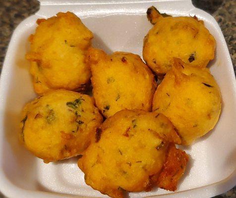 Hot fresh punugulu (lentil fritters) at the snack counter inside the grocery store