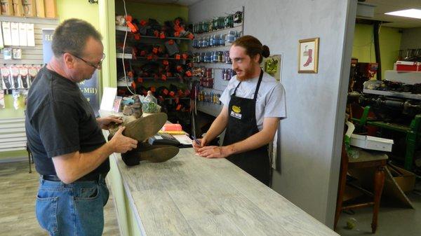 Owner and Operator Jacob Azar serves a customer at Midway Shoe Repair in Largo, FL.