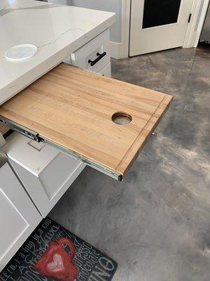 Cutting board with access to tras can