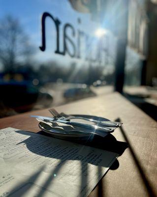 Bar seating at Pizzeria Florian looking out at Main Street East Aurora.