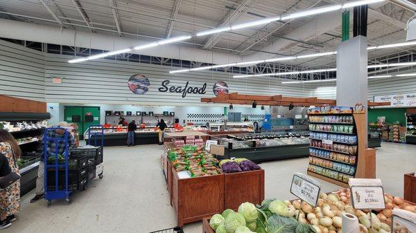 Standing at the end of the fruits and veggies looking at the seafood.