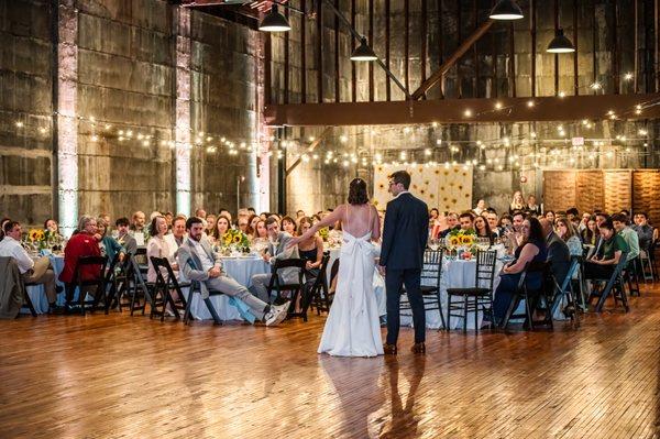 Bride and groom talk to guests at Olio modern industrial event space north of Boston Massachusetts, New England