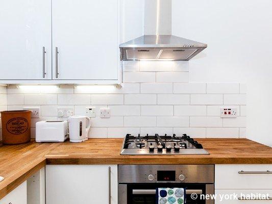 Fully-stocked kitchen in a furnished apartment rental.