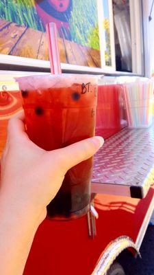 Raspberry black tea with boba.