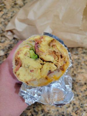 Breakfast Burrito with bacon, avocado and onions.