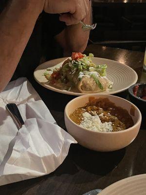 Burrito loco with salad on top and refried beans