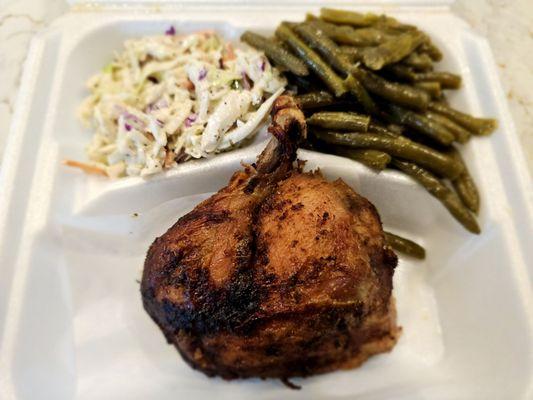 Quarter chicken with coleslaw and green beans.