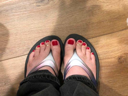 Red pedicure with perfect polish.