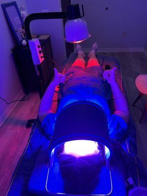 Feeling good, the patient is enjoying LED light therapy after Micro-needling