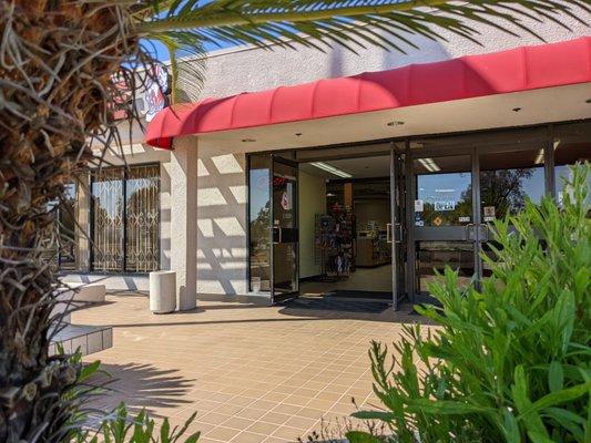 Front Entry of the Rancho Army-Navy Store featuring a seating area and a ramp.