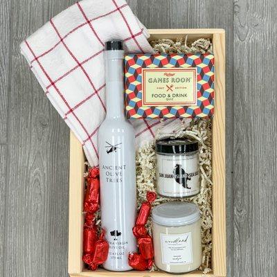 Olive oil, sea salt, game, scented candle, dish towel, truffles, wooden slide lid box.