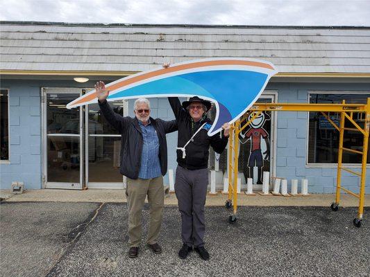 Hanging the Kitty Hawk Kites sign!