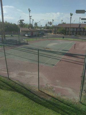 The tennis court area all messed not a place for the kids to play.