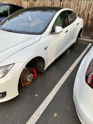 Someone stole the wheels off this car and put it on cinderblocks.