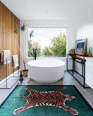 This primary bathroom remodel in the Oakland hills underwent layout changes and the addition of a picture frame window.