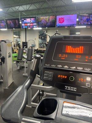 Stationary bike with tvs in the background