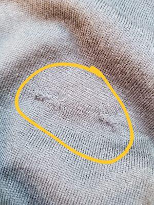 Damaged part in the front my of sweater. Apparently he stitched these for me