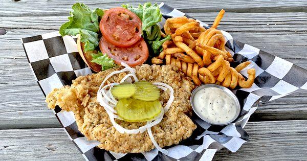 Pork Tenderloin - Pounded and breaded in house, Served on brioche bun with lettuce, tomato, pickle, onion, and our house made remoulade