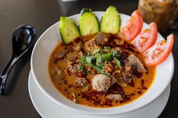 Pho Sa Te -  Rich, spicy beef broth with chili oil, peanut, cucumber, tomatoes, and fresh herbs