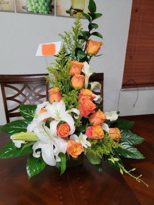 Beautiful floral arrangement with roses, callas, and lilies