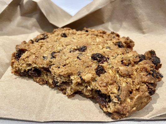 Partially eaten giant, fantastic oatmeal raisin cookie