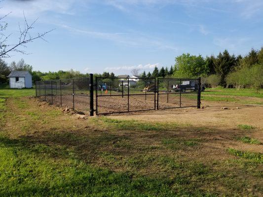 6' black vinyl chain link fence with 24' wide double gates